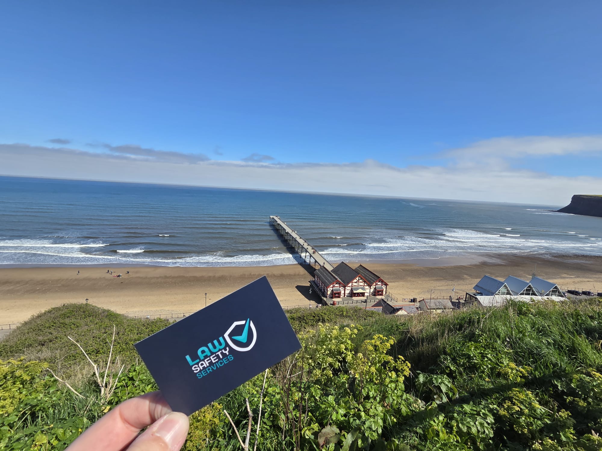 Law Safety Services business card above Saltburn pier