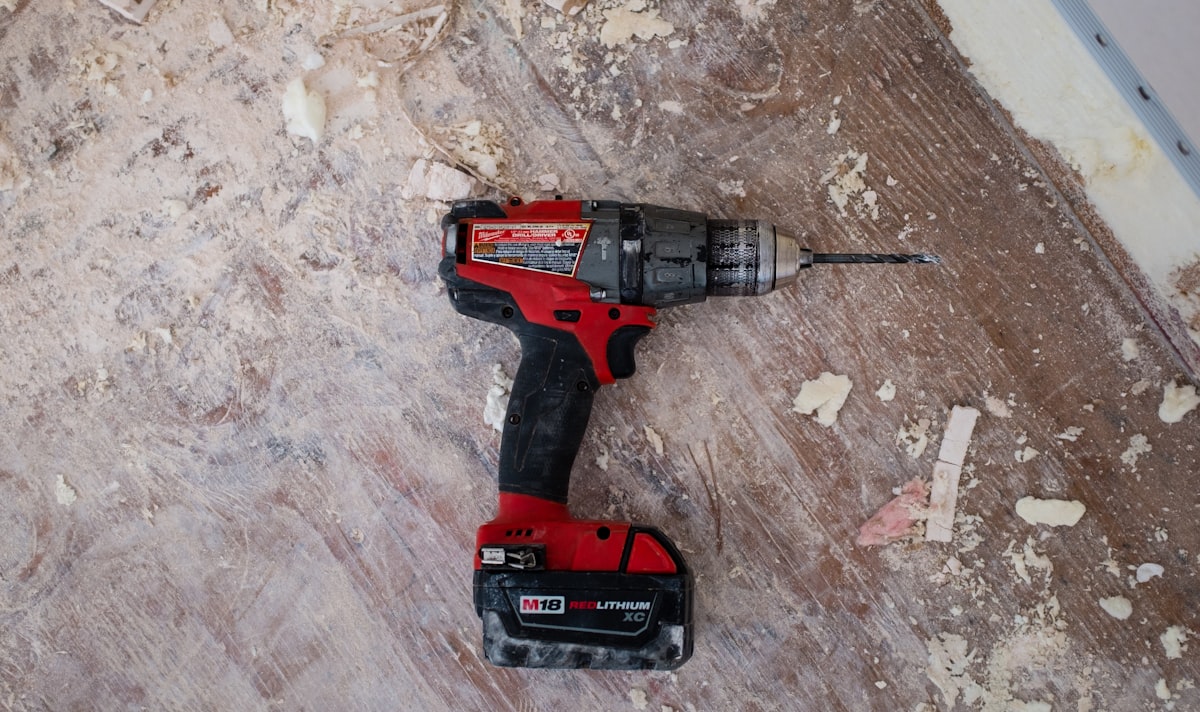 Gloved hands using a power tool